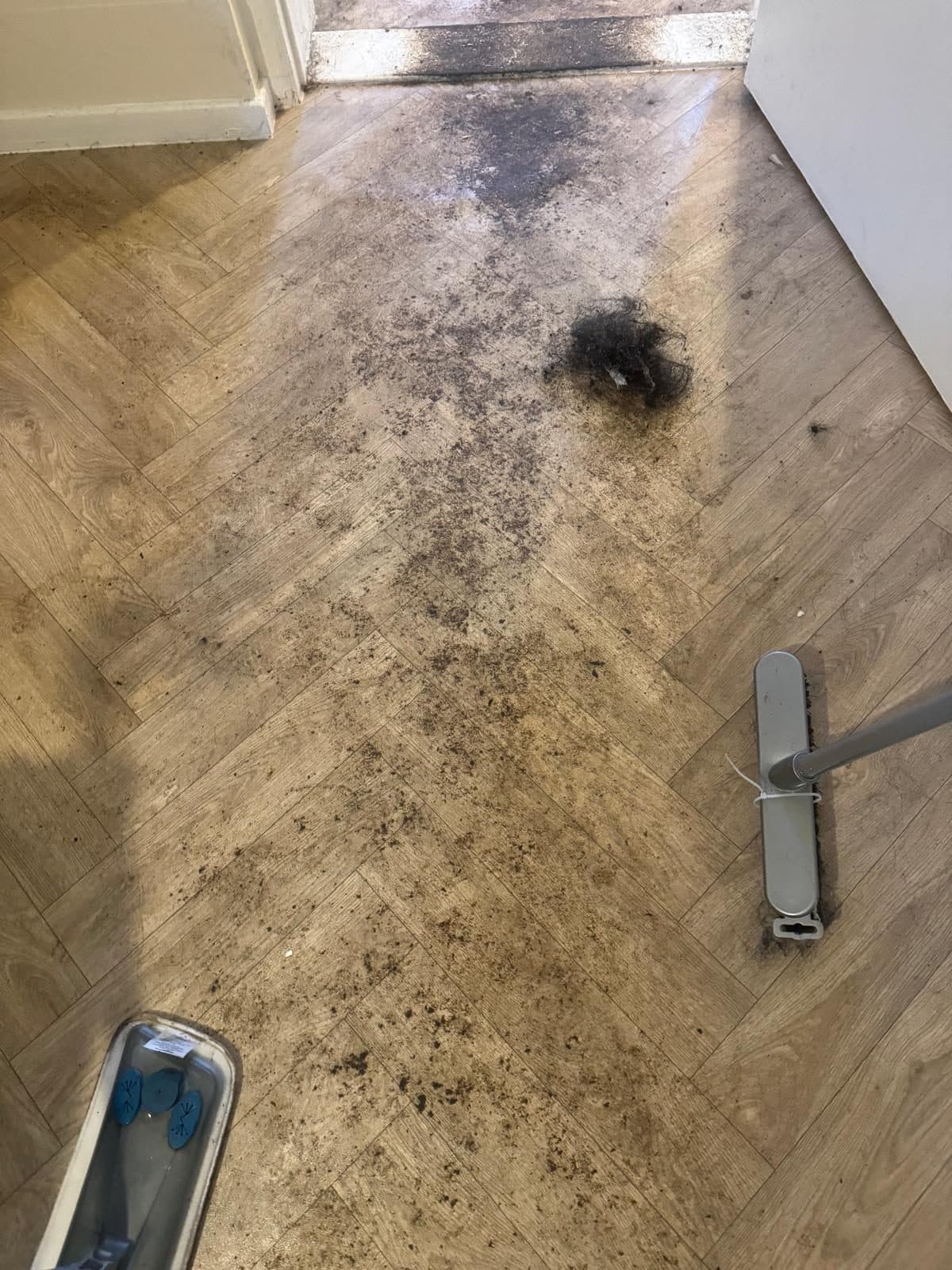 Herringbone floor covered in dirt and debris