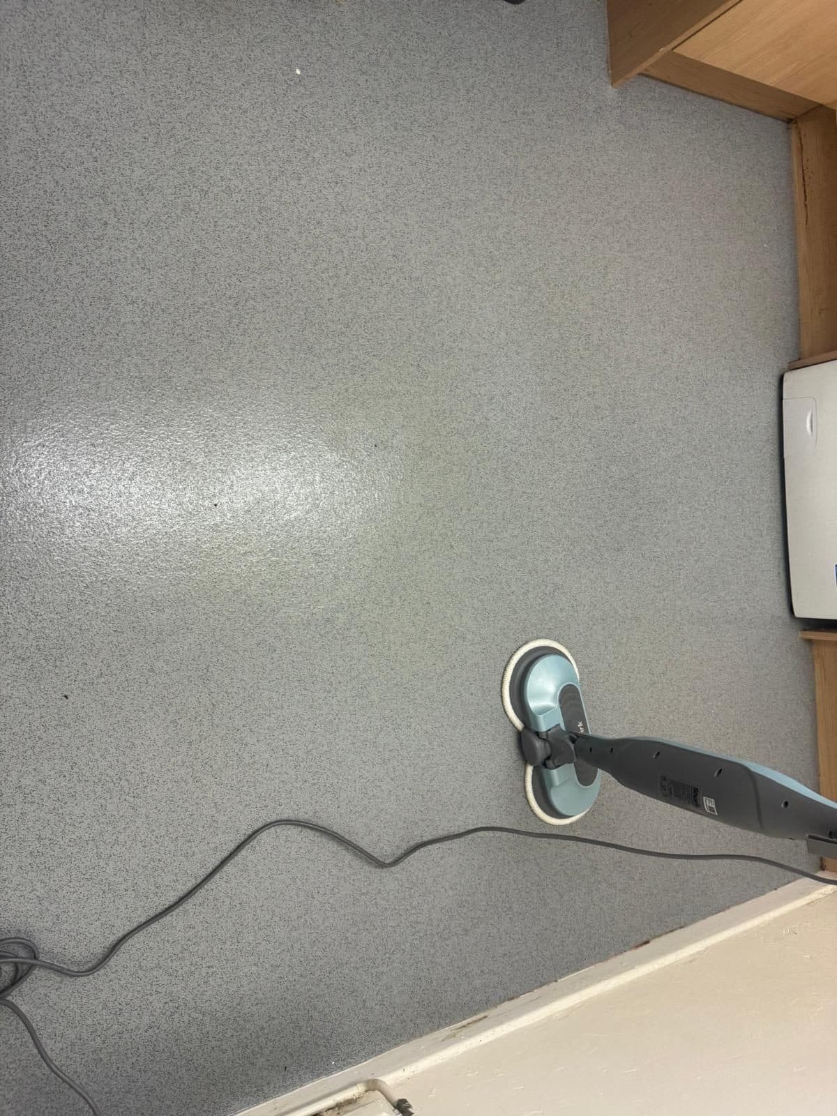 The vinyl floor after cleaning, with an even sheen